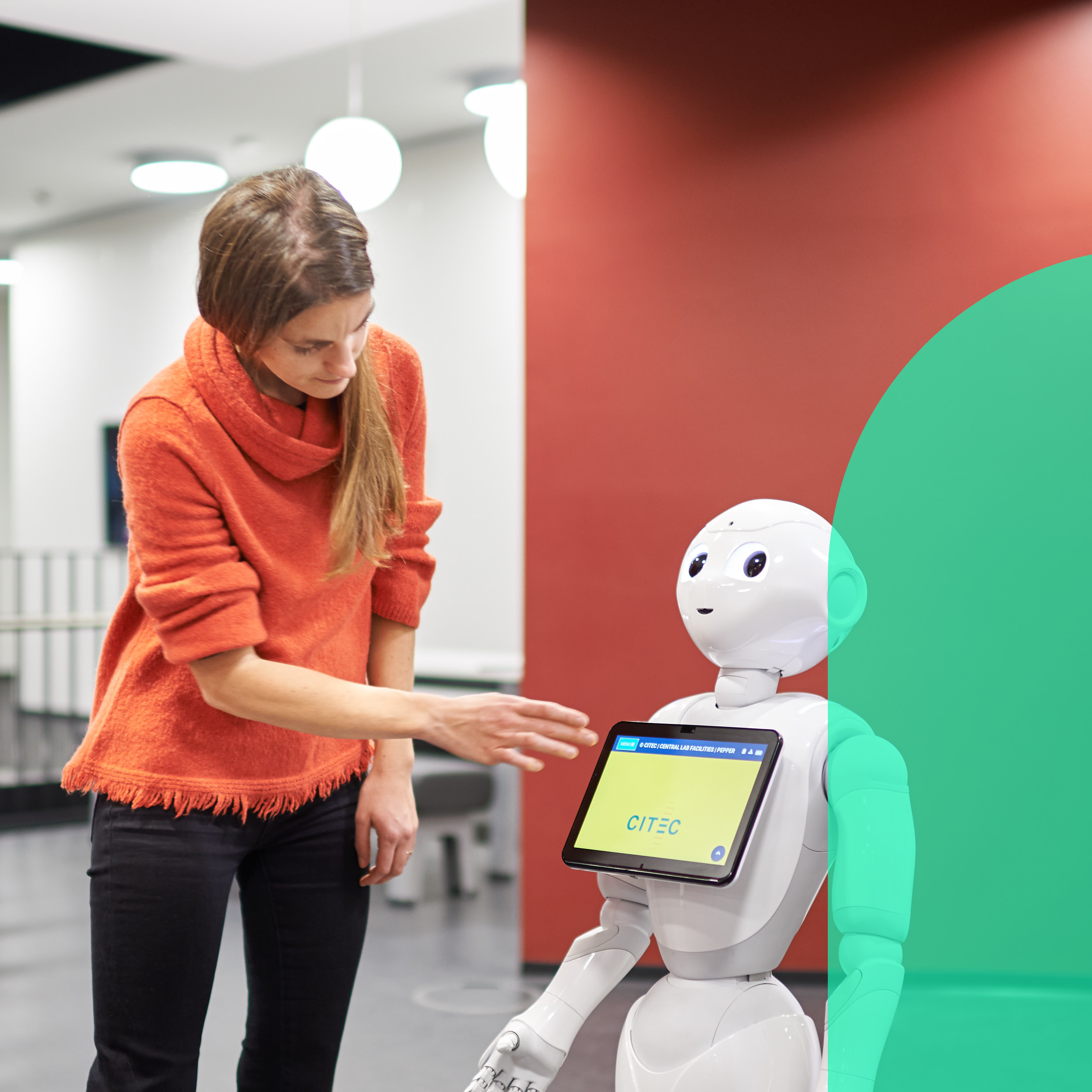 Woman researcher operates the display of a service robot
