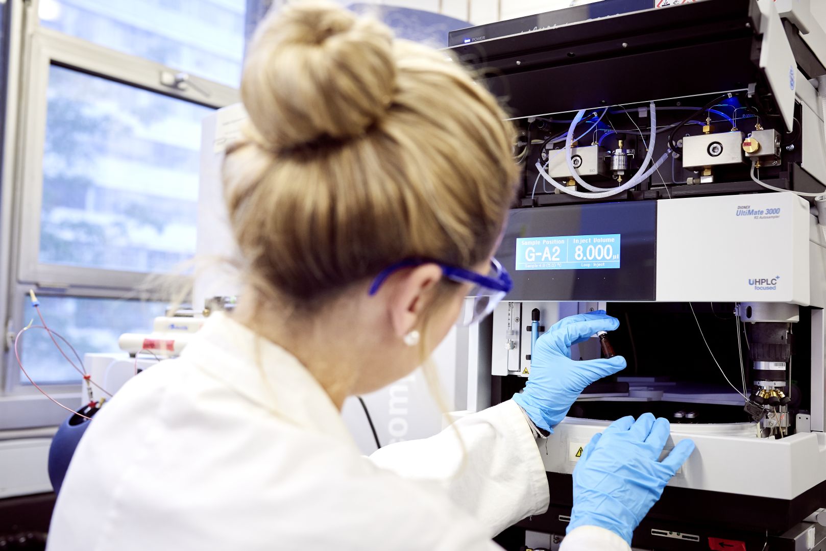 Researcher examines chemical lab sample