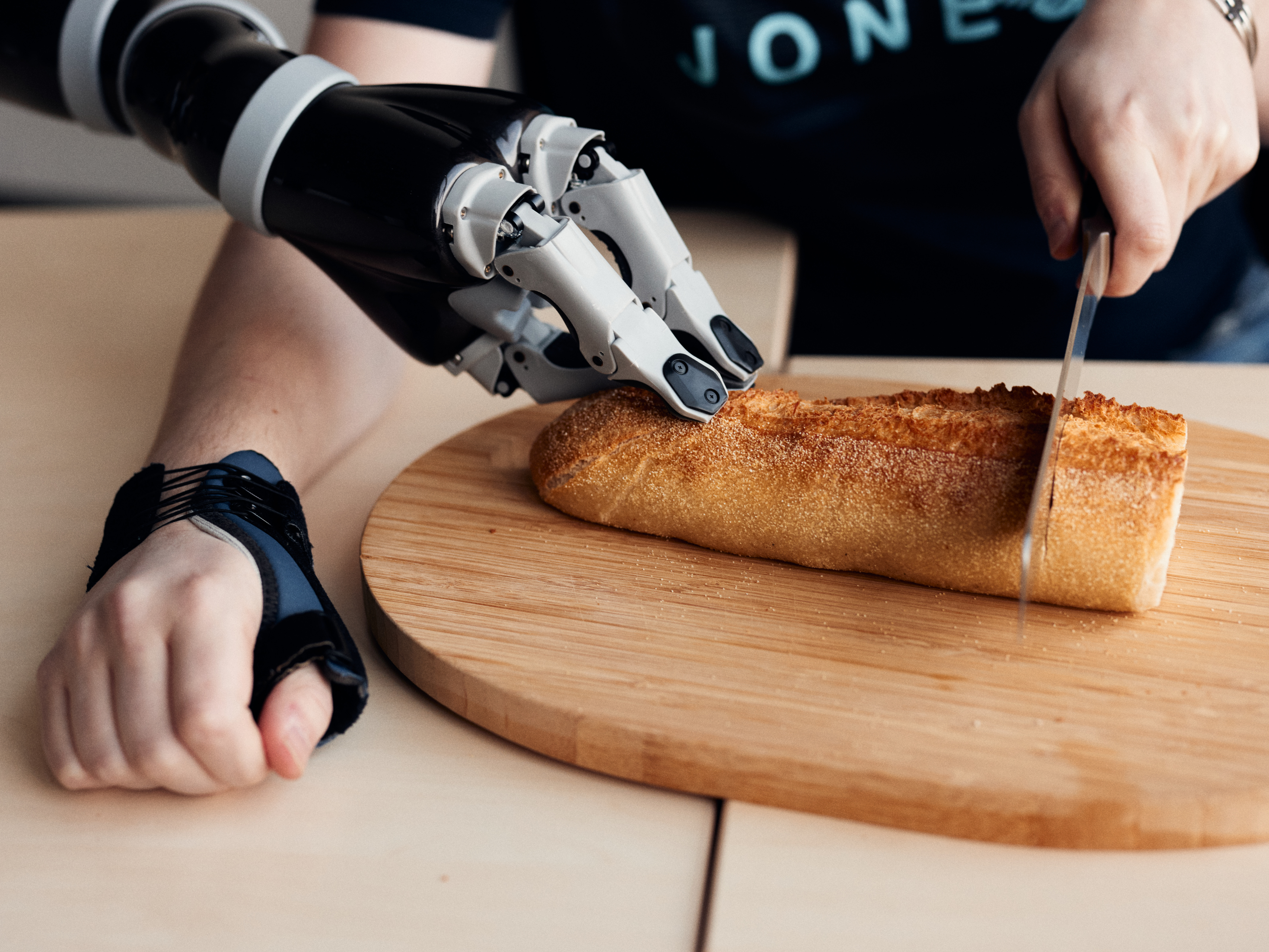 Robot arm holds bread to be cut