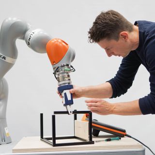 A robotic hand and a human working together